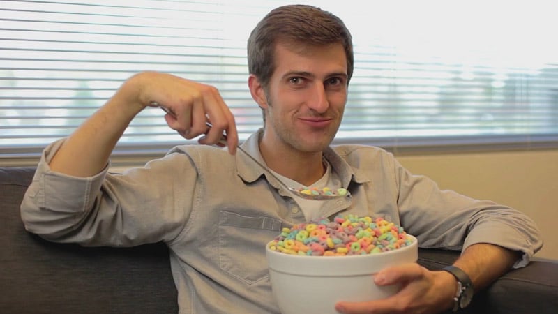 Man holding a giant spoon and bowl of cereal - an example of an empowering sales video