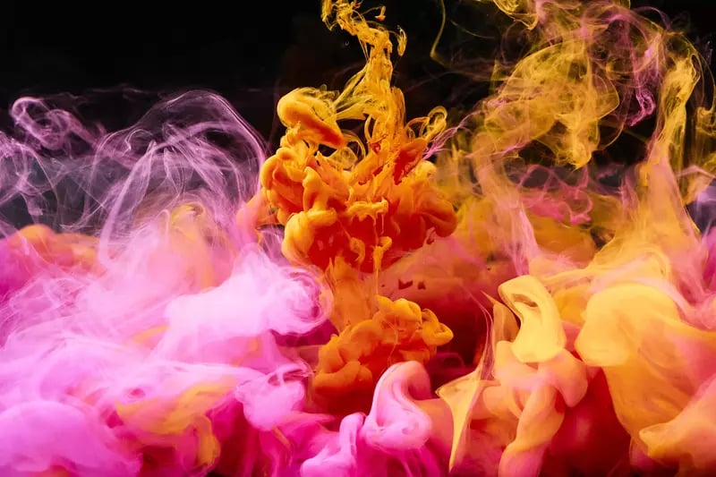 Pink and orange smoke, used to showcase the balance between art and technical skills