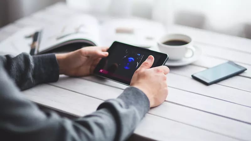 Mini tablet and cup of coffee