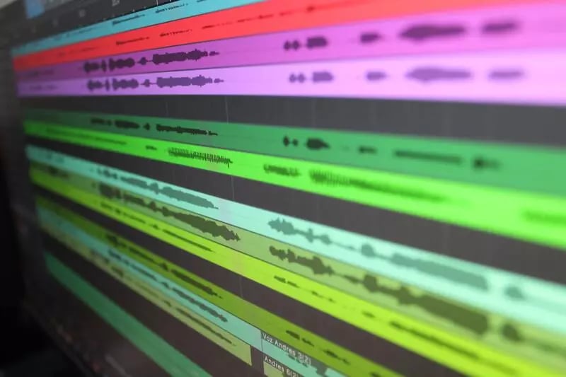 A screen showing audio waves in blue, red, pink, purple, and shades of green.
