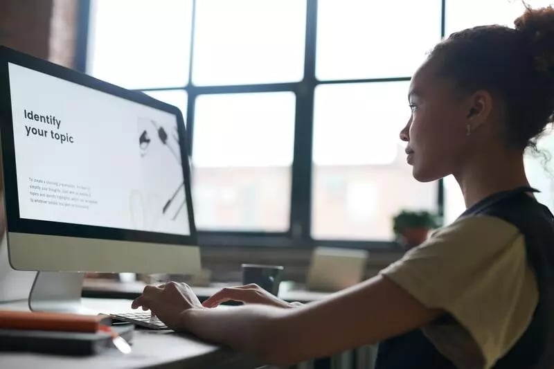 Woman at computer learning the benefits of training videos